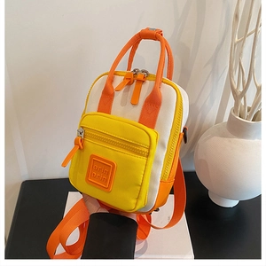 Detail of multi-color canvas backpack with orin orin rubber logo patch and zipper pocket