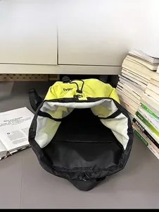 Top view of large capacity nylon backpack interior with black drawstring closure and lining
