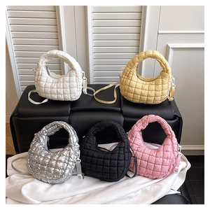 Detailed close-up of colorful quilted cloud bags with adjustable shoulder straps