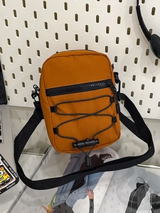 Outdoor style mustard yellow nylon crossbody bag with tactical bungee cord detail