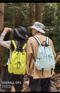 Detail of waterproof nylon drawstring backpacks in fluorescent yellow and light blue colors