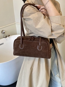 Brown vintage suede baguette shoulder bag with stylish white stitching on the handle