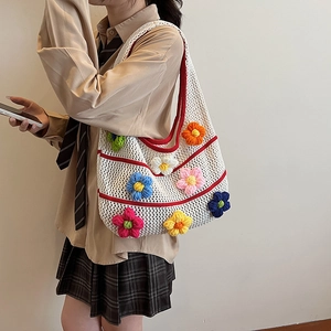 Floral crochet knit tote bag with colorful 3D flowers and red trim in a beige grid style