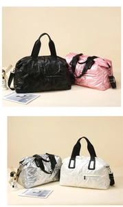 Close-up of quilted nylon travel bags in black, pink, silver and white with metal zippers