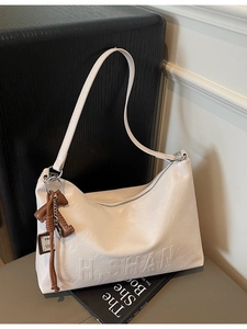Off-white pebbled leather hobo bag with embossed H.SHAN logo and dog charm pendant