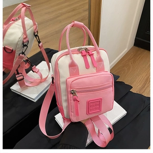 Rear and front view of pink multi-functional canvas backpack and handbag via mirror reflection