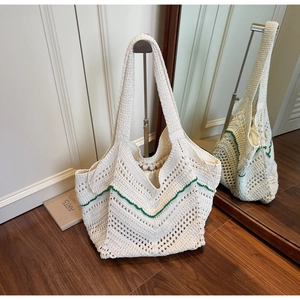 Macro detail of beige woven tote bag showing green wave pattern and drawstring inner lining