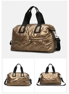 Detail of gold quilted travel bag with diamond stitching and adjustable black straps