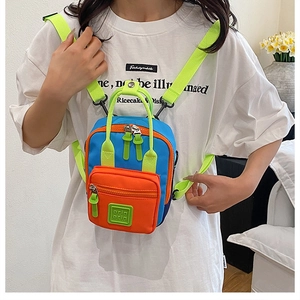 Mini nylon backpack in blue and orange with neon green straps and square rubber logo