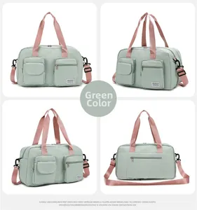Detail view of green travel duffel with pink straps and multi-functional storage pockets