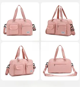 Front and side view of pink multi-pocket travel duffel bag with detachable shoulder strap