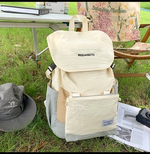 Detail view of large canvas outdoor backpack with buckle on green grass background