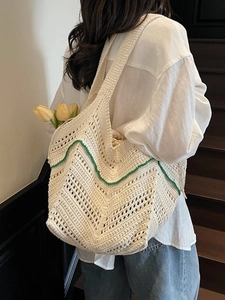 Chic cream knit tote bag with green wavy trim and internal drawstring liner
