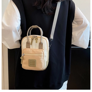 Detailed shot of multi-functional color-block canvas crossbody bag with adjustable strap