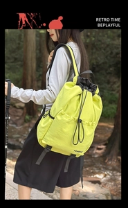 Detail of waterproof fluorescent green nylon backpack with drawstring closure for hiking