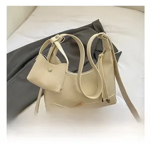 Detailed macro view of the cream-white litchi grain faux leather bag with mini pouch