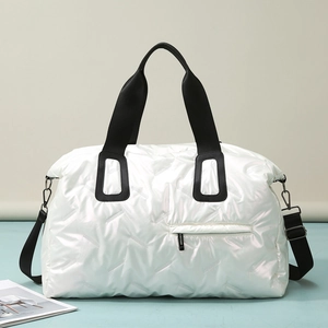 Large white quilted travel tote bag with metallic finish and adjustable shoulder strap