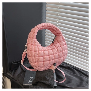 Close-up of pink quilted cloud bag with diamond texture and elegant zipper detail