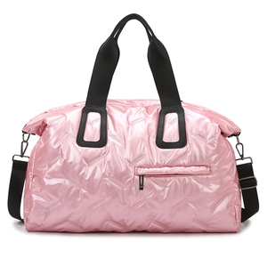Pink metallic puffer travel bag with quilted padding and adjustable black shoulder strap