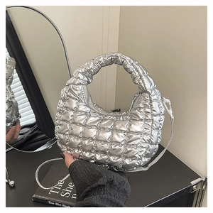 Detailed close-up of a metallic silver quilted dumpling bag with a smooth zipper closure