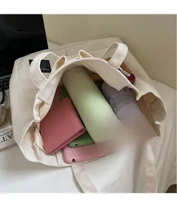 Large white canvas tote bag showing interior storage capacity for daily essentials