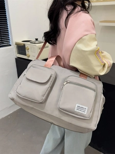Large capacity grey travel bag with pink straps for gym, sports and short weekend trips
