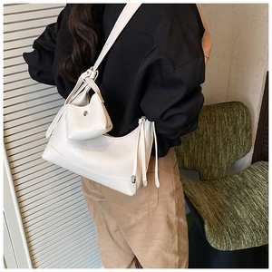 Detailed close-up of white lychee textured shoulder bag with matching mini coin purse pouch