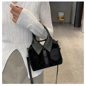 Close-up of creative shirt-collar design black velvet handbag with unique button details
