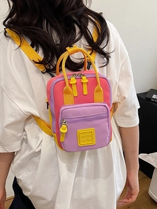 Multicolor mini nylon backpack with bright pink, purple, and yellow accents and adjustable straps
