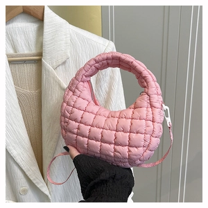 Detailed shot of pink quilted bubble hobo bag with silver zipper and shoulder strap