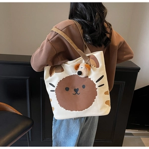 Rückansicht einer weißen Canvas-Tragetasche mit Cartoon-Aufdruck und Plüschhund-Anhänger