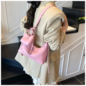 Detail of pink hobo bag with matching mini pouch showing soft pebbled leather texture