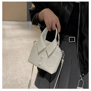 Detail of creative shirt-shaped crossbody bag featuring white lapels and button accents