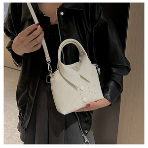 Detail of creative shirt-shaped crossbody bag in cream white with collar and button design