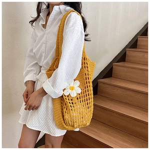 Détail du sac à bandoulière en tricot jaune avec fleur de marguerite et doublure