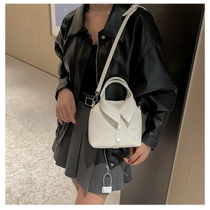 Detailed view of white shirt-inspired crossbody bag with collar and button accents