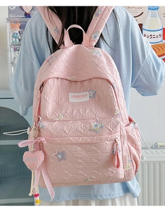 Pink quilted star backpack with sequin embroidery and heart charm detail