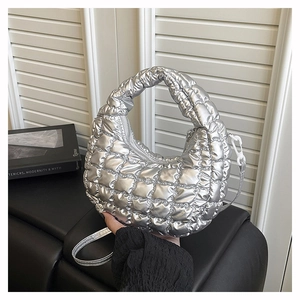 Detail of silver metallic quilted bubble bag with puffy lattice texture and slim strap