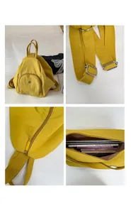Detail view of mustard yellow backpack showing adjustable buckles and smooth metal zippers