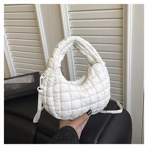 Detailed close-up of a white quilted bubble handbag with soft cloud-like padded texture