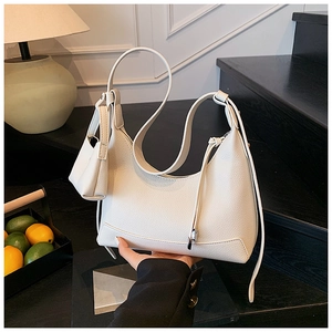 Close-up of a white lychee grain leather Hobo bag with detachable coin purse on a wooden step