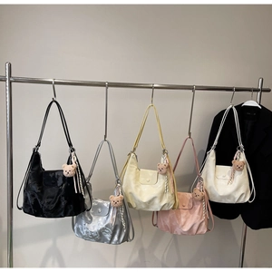 Five shiny pleated leather hobo bags in assorted colors with cute teddy bear charms