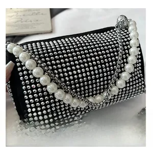 Close-up of luxury Boston bag featuring sparkling rhinestones and elegant pearl handle