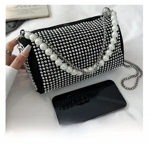 Detail showing the sparkling rhinestone Boston bag with faux pearl handle and metal chain strap