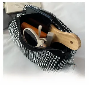 Macro view of crystal boston bag interior showing high capacity for smartphone and makeup