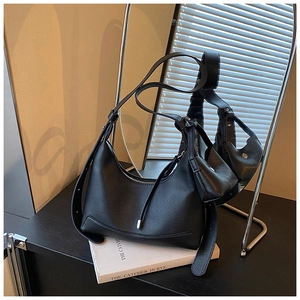 Detail of black lychee grain leather hobo bag with adjustable strap and mini coin purse