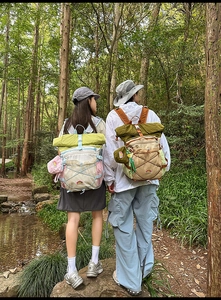 Close-up of contrast color outdoor backpack with roll-top closure and bungee system