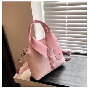 Detailed view of pink creative shirt-collar handbag with decorative buttons and pocket