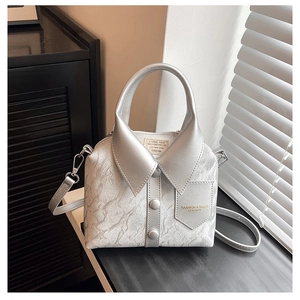 Detail of silver shirt-collar handbag with metallic finish, buttons, and shoulder strap
