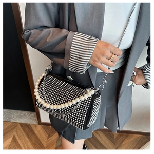 Detail of Boston cylinder bag featuring silver rhinestones and large pearl handle